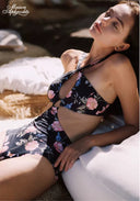 Floral halter one-piece swimsuit with bow tie neck and high-leg cut, dark base with pink flowers
