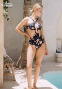 Floral halter one-piece swimsuit with high-leg cut, dark base with pink flowers