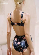 Floral high-waist bikini back view, black with pink flowers and crisscross straps