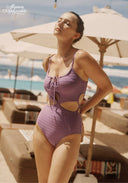 Purple cut-out swimsuit with crisscross lace detail at the chest