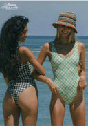 Two women wearing checkered one-piece swimsuits with scoop necklines and thin straps.