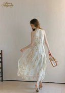 Floral sleeveless midi dress back view with flowing gathered tiers and ruffled hem
