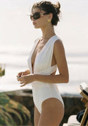 Ivory one-piece swimsuit with deep V neckline and draped front panel