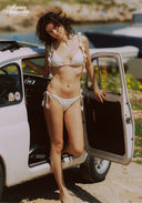 White bikini set with triangle top and tie side bottoms, standing by open car door