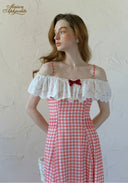 Close view: off-shoulder gingham plaid maxi dress with white lace trim and red bow