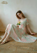 Pastel floral dress with lace-trim bodice, tiered skirt, and puff sleeves