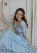 Light blue lace midi dress with puff sleeves and square neckline, tiered skirt.
