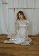 Floral satin midi dress with puff sleeves and gathered waist, skirt falls in soft folds