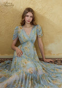 Light blue floral midi dress with puff sleeves, V-neck bodice, and tiered skirt