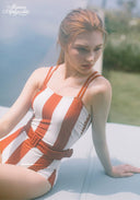 Orange and white striped halter one-piece swimsuit, front seated pose