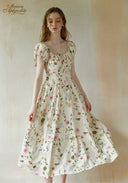 Floral maxi dress with round neckline, short puff sleeves, and flared skirt, white