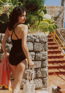 Black cut-out one-piece swimsuit with halter straps and ringed back center cut-out