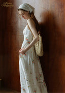 Floral tiered maxi dress with spaghetti straps, worn with a light headscarf