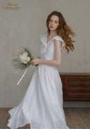 White lace midi dress with ruffle-trim neckline, fitted bodice, flowing full skirt