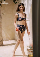 Floral high-waist bikini on model, black with pink floral print and tie-back straps