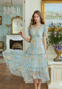 Light blue floral midi dress with puff sleeves, V-neck, and tiered skirt
