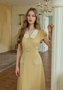 Yellow embroidered dress with peter pan collar and button front, side seam detail