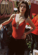 Red one-piece swimsuit with thin straps, scoop front, and gold teardrop charm