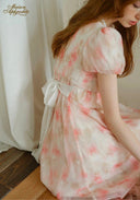 Sunset dress in light pink floral print, puff sleeves, tied waist detail, flowy maxi skirt