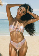 Woman in a floral bikini on a beach