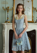 Light blue sleeveless lace patchwork dress with V-neck and gathered knee-length skirt