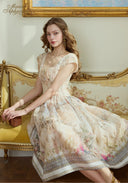 Cream floral printed dress, square neckline, cap sleeves, gathered waist, full skirt, seated