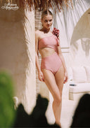 Pink one-shoulder swimsuit with rosette shoulder detail and high-cut bottom