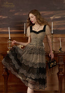 Black mesh lace dress with V-neck, short sleeves, and scalloped tiered skirt