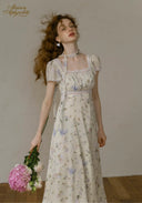 Floral tea dress with choker-style collar, short puff sleeves, and midi length skirt