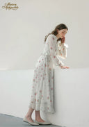 Floral midi dress with ruffled shoulders and long sleeves, side view