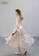 Floral tiered dress in pale pink with ruffled sleeves, long skirt side view
