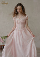 Pale pink dotted midi dress with puff sleeves, lace corset seams, and gathered skirt
