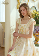 Cream linen mini dress with yellow floral embroidery, square neckline, cap sleeves.