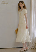 Lace tea dress in pale yellow with V-neck and puff sleeves, full-length side view