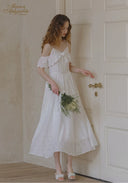 White lace midi dress with thin straps, ruffled neckline, gathered waist, full skirt