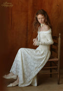 Full-length white lace ballet dress with long sleeves and gathered skirt