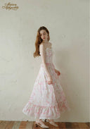 Light pink floral sundress with lace-trim square neckline, spaghetti straps, ruffled tiers