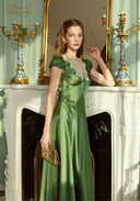 Green satin long dress with lace V neckline, short puff sleeves, and side bow at waist