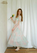 Pastel floral dress with gathered waist, lace details, and flowing tiered skirt