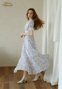 Lavender floral midi dress with puff sleeves and square neckline, side stepping view.