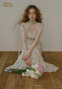 Floral tea dress with fitted bodice, short puff sleeves, and midi skirt length