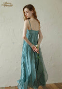 Teal satin midi dress with spaghetti straps and ruched bodice, side view
