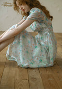 Light blue floral dress detail, square neckline and puff sleeves, gathered waist