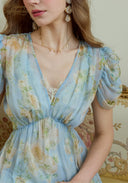 Light blue floral V-neck dress with puff sleeves and gathered waist