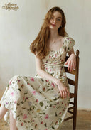 Floral dress with gathered bodice, short puff sleeves, and full skirt, white base