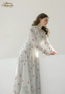 Floral midi dress with ruffled neckline and long sleeves, angled side view