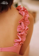 Pink ruffle trim on swimsuit strap detail
