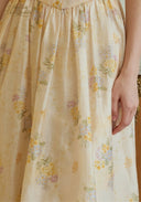 Cream fabric with yellow and pink floral print, gathered skirt hem detail
