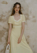 Romance dress in pale yellow with lace-trim square neckline and short puff sleeves