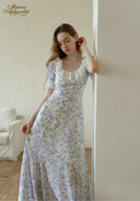 Lavender floral midi dress with square neckline, puff sleeves, and flowing gathered skirt.